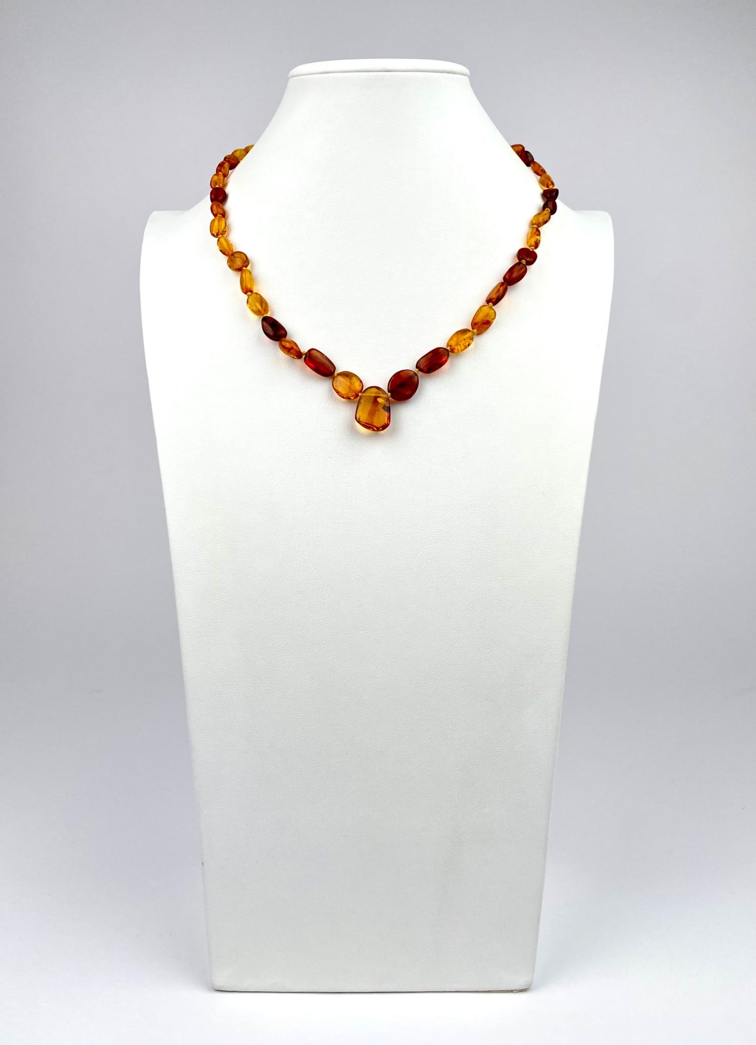 Amber-tone bead necklace featuring polished oval and irregular-shaped beads in varying shades of (1 of 6)