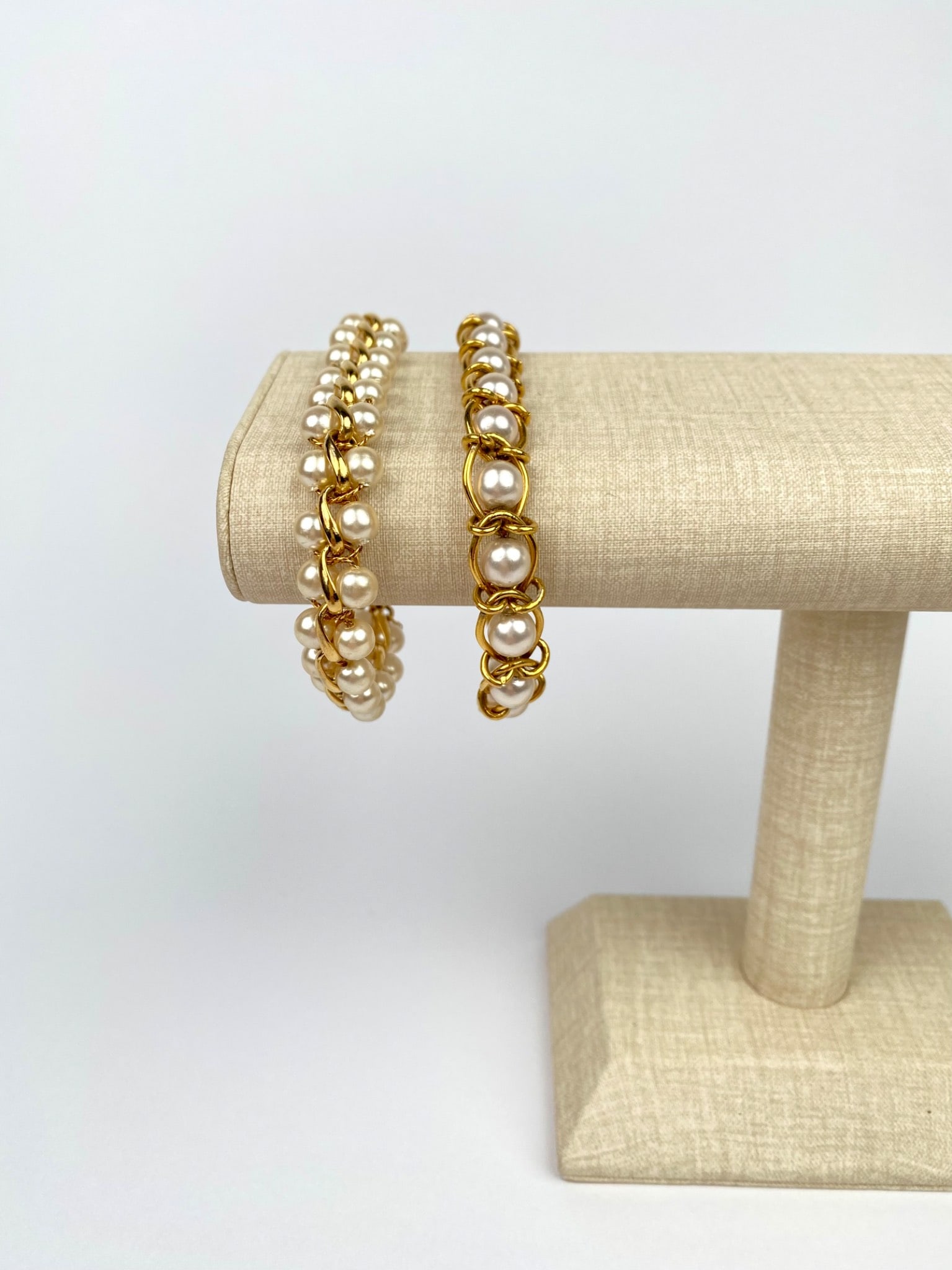 Two Gold-Tone & Faux Pearl Link Bracelets (One Signed Napier): Two gold-tone link bracelets featuring faux pearl accents. Each bracelet is constructed with a gold-tone chain and fold-over clasps. One bracelet is engraved with the Napier name. | Please see photos