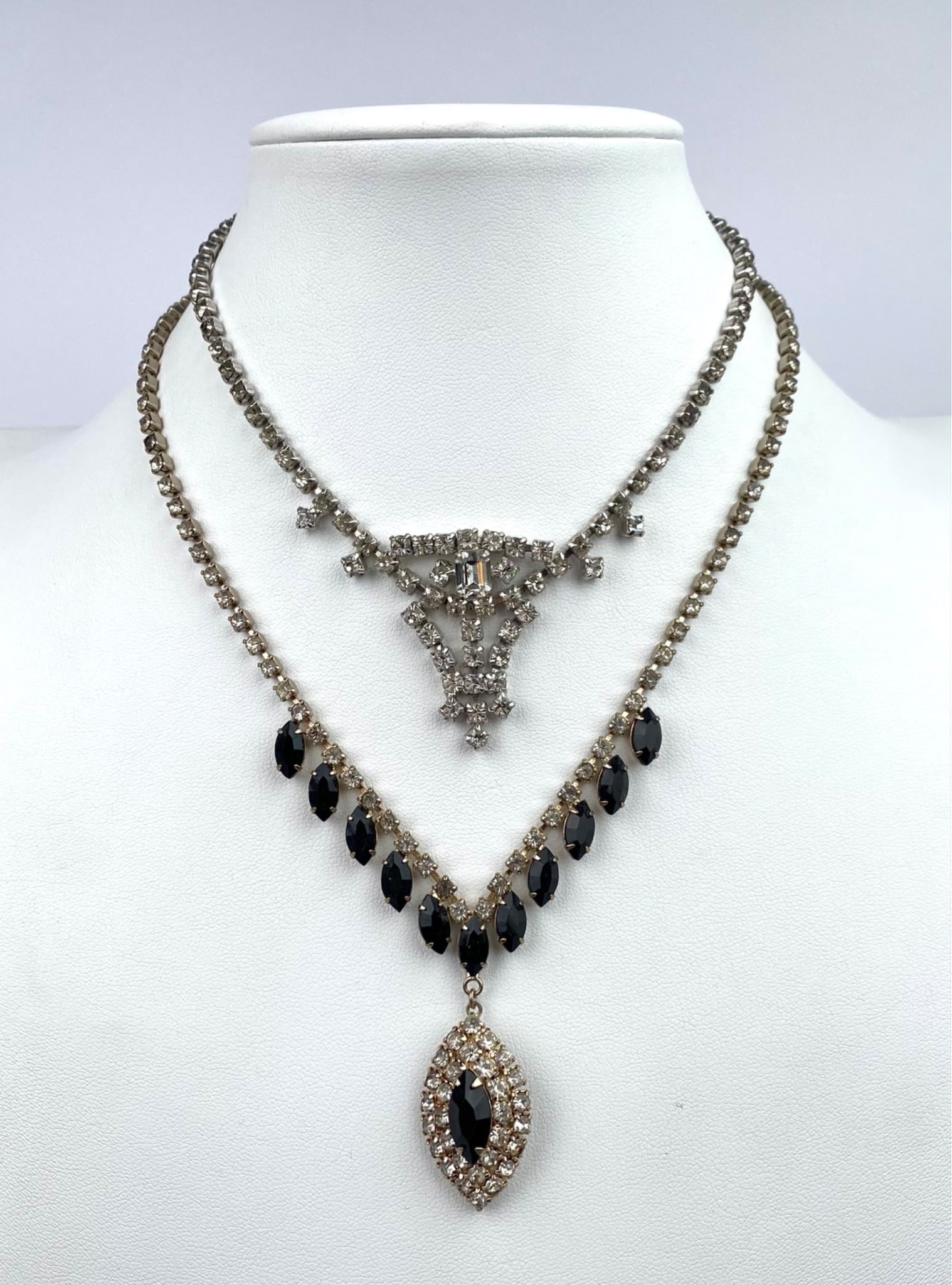 Necklaces featuring a silver-tone setting. One necklace is designed with clear rhinestones and black (1 of 7)