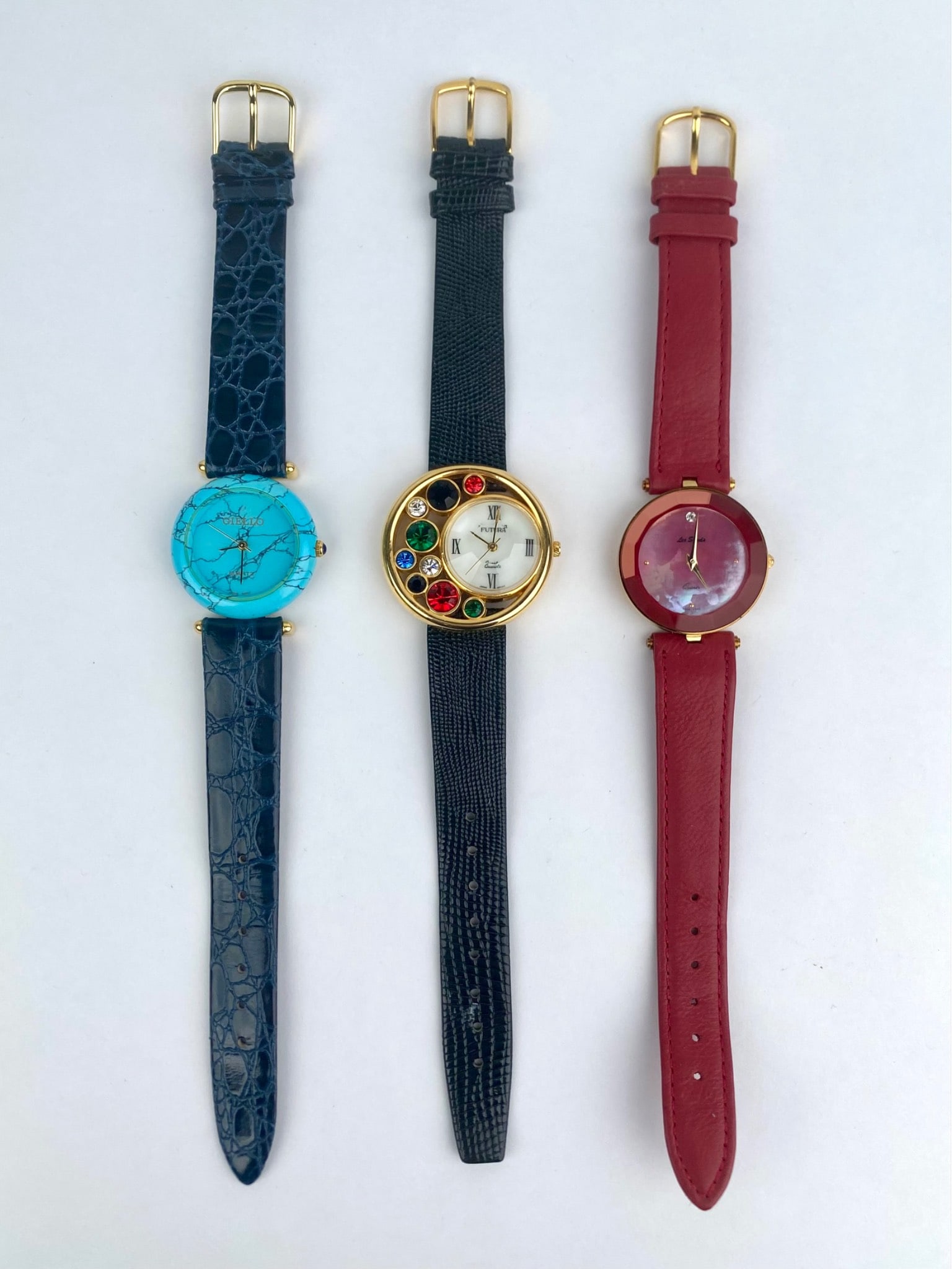 Three Ladies’ Quartz Wristwatches with Leather Bands: Group of three ladies' quartz wristwatches featuring decorative dial designs and genuine leather straps. Includes a Giello watch with turquoise-style dial and blue leather band, marked Hong Kong assem
