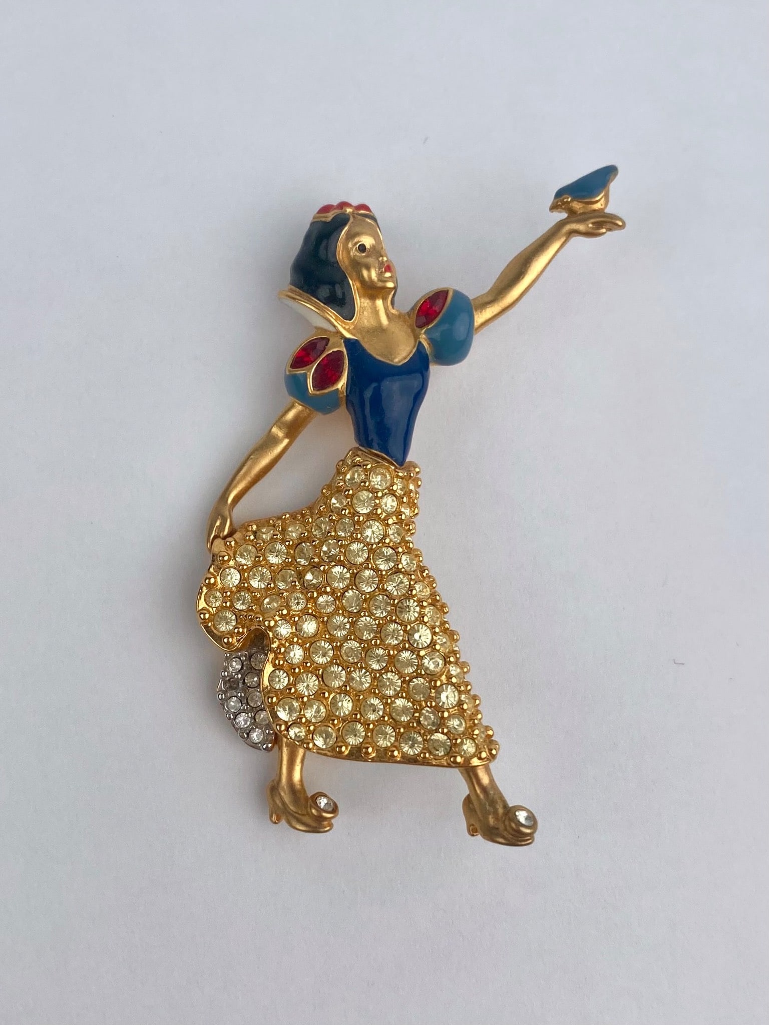 Disney Snow White 65th Anniversary Swarovski Crystal Brooch: Disney Snow White figural brooch commemorating the character's 65th anniversary, as marked on the reverse with the date of the original film release "LE 1937." The brooch is finished in gold-tone