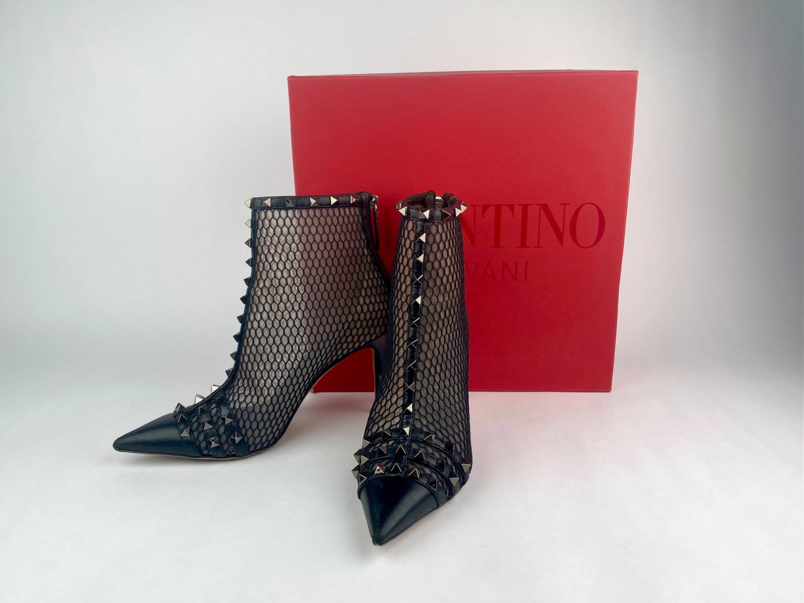 Pair of Valentino Garavani Rockstuf Alcove ankle boots, featuring black leather pointed toes with: Pair of Valentino Garavani Rockstuf Alcove ankle boots, featuring black leather pointed toes with mesh uppers and signature pyramid Rockstud hardware running along the vamp, shaft, and collar. The boo