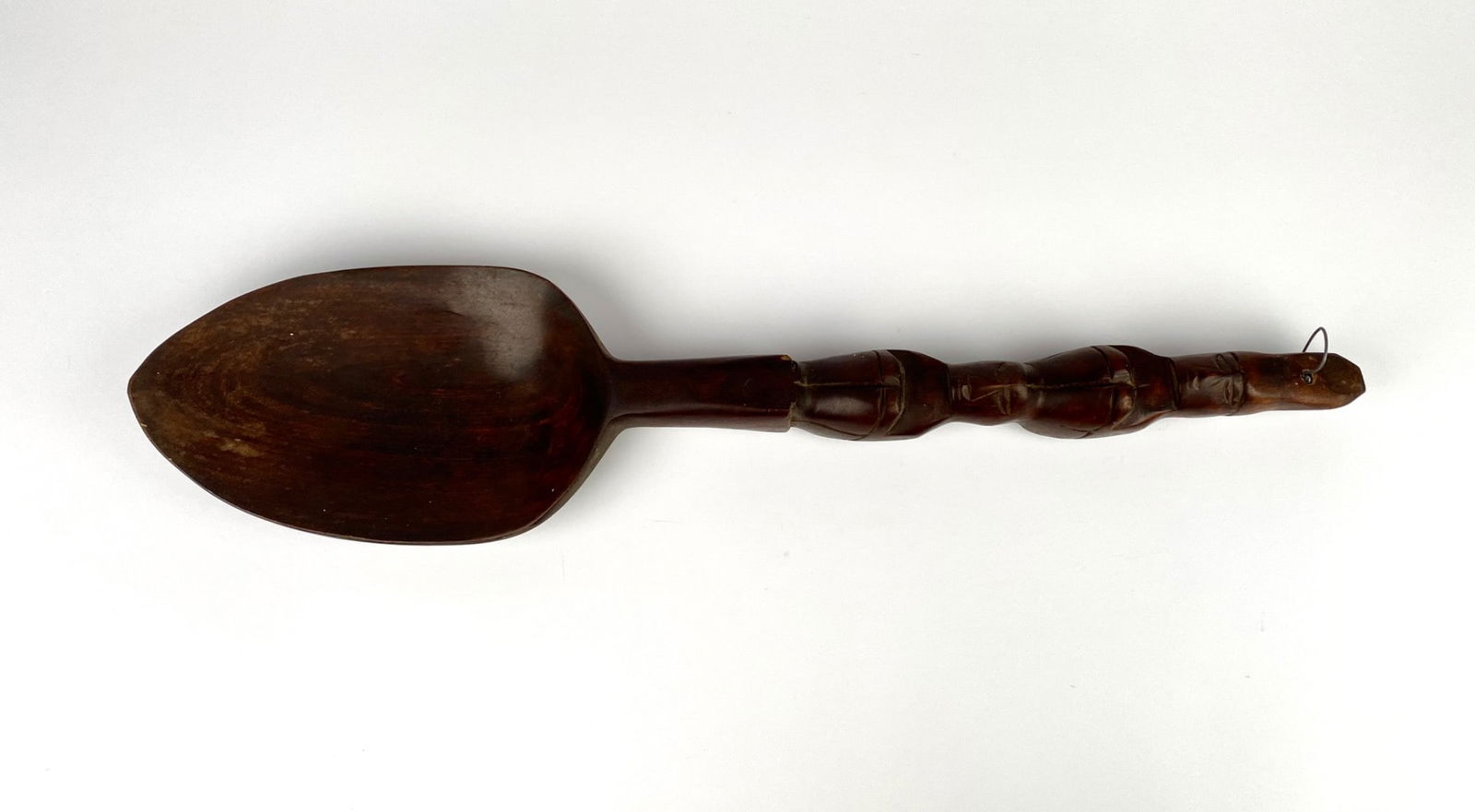 Large hand-carved wooden spoon featuring a unique handle design with carved decorative elements and (1 of 8)