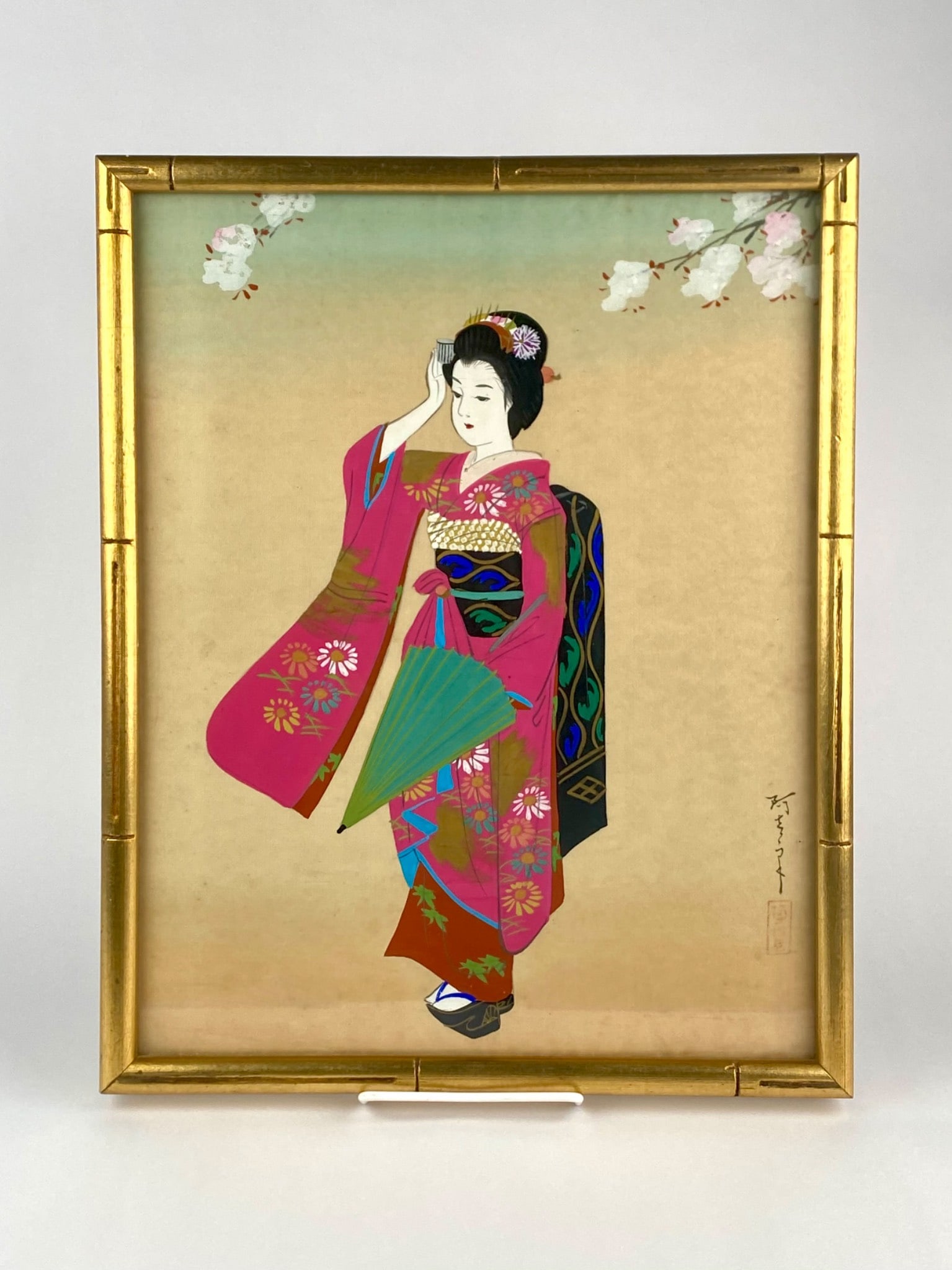 Japanese Bijin-ga Style Painting of Kimono-Clad Woman: Japanese bijin-ga style painting on fabric depicting a woman wearing a brightly colored floral kimono and traditional hairstyle with decorative hair ornaments. The works bears a vertical Japanese sign