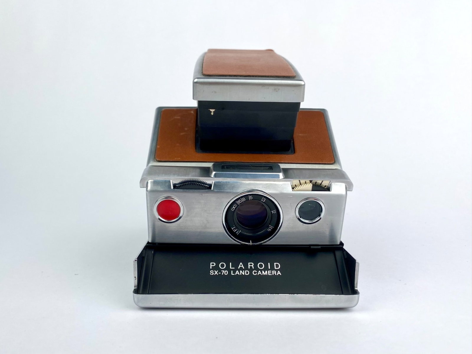 Vintage Polaroid SX-70 Land Camera instant camera manufactured by Polaroid Corporation, Cambridge,: Vintage Polaroid SX-70 Land Camera instant camera manufactured by Polaroid Corporation, Cambridge, Massachusetts. This folding SLR camera features a brushed metal body with brown leather panels and co