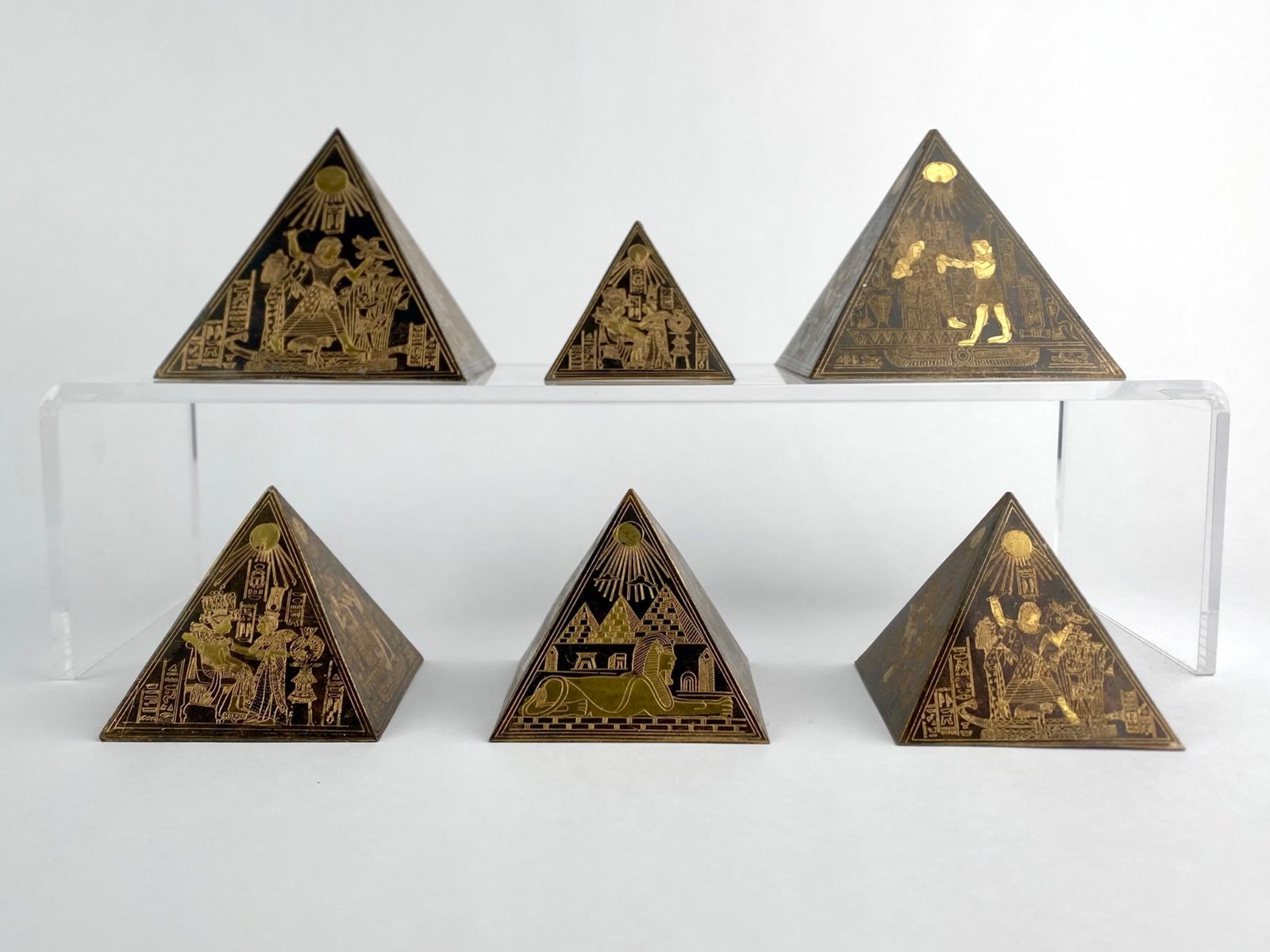 Lot includes a set of six Egyptian revival pyramid-form paperweights constructed from etched brass (1 of 8)