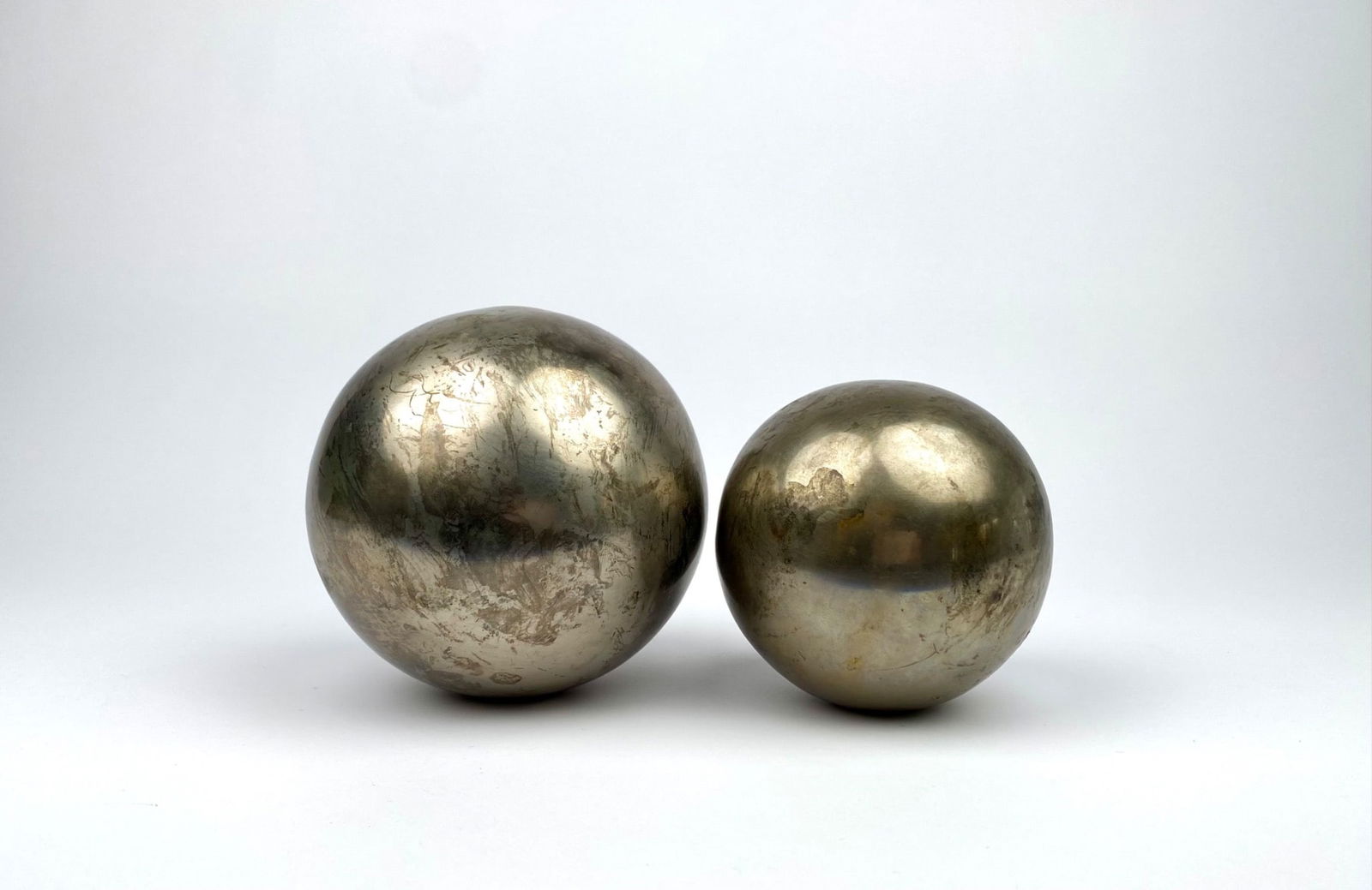 Spherical objects featuring a silver-toned metallic finish with visible wear and patina. Each sphere (1 of 7)