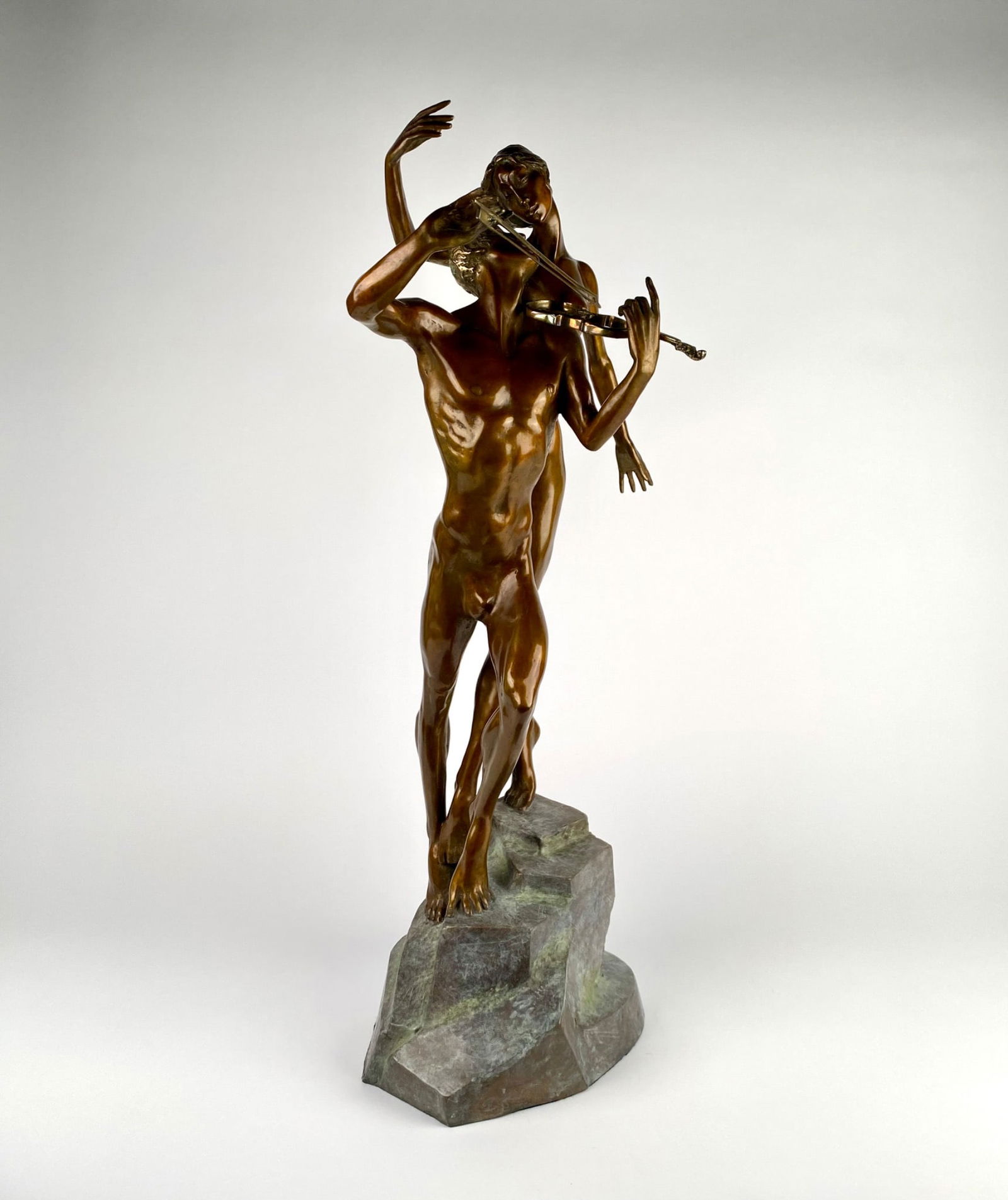 M. Frid Bronze Sculpture ‘Violinist & Muse,’ Limited Edition 97/195: Bronze sculpture by artist M. Frid, marked 97/195. The piece portrays two intertwined figures, one playing a violin, mounted on a stone-like bronze base. Features detailed craftsmanship and signed by