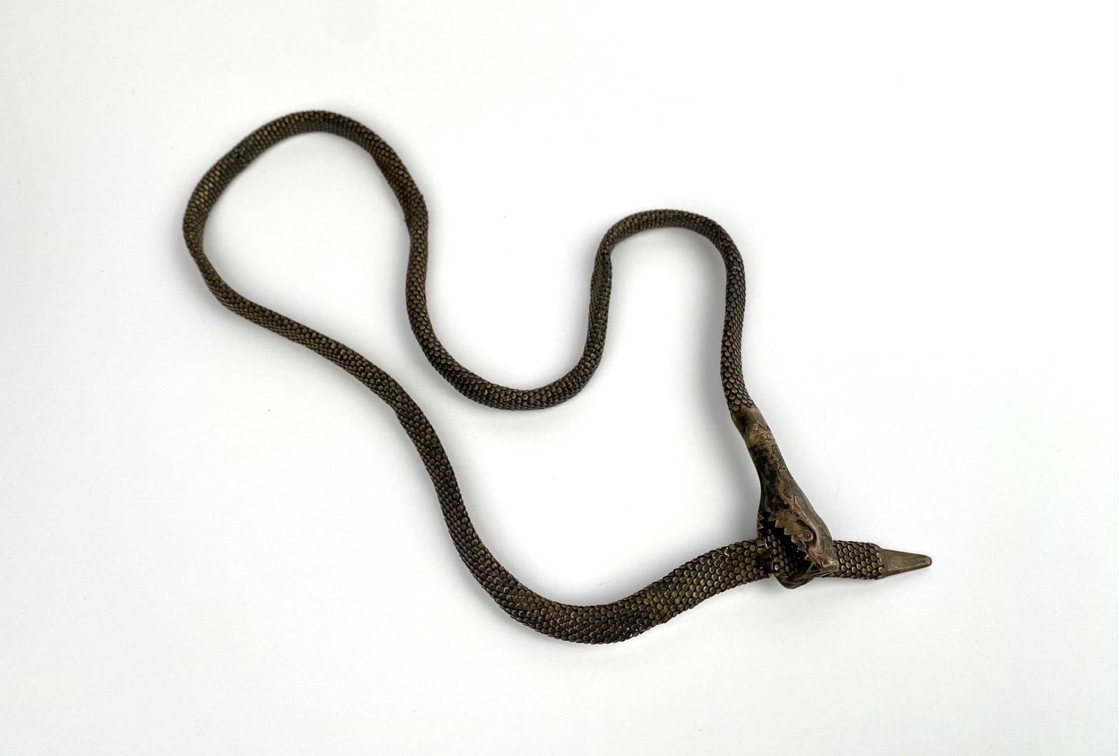 Antique Silver Snake-Form Necklace, Marked ‘800’: Silver snake motif flexible necklace featuring intricate scale detailing and marked ‘800’ silver. The design includes a detailed snake head with ruby-like stones as eyes and an open mouth clasp