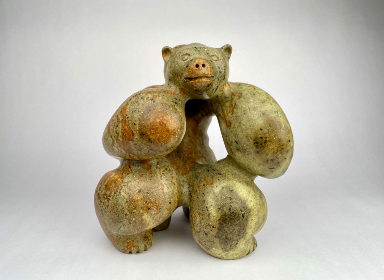 Stewart Steinhauer, Bear & Human Figure, Cree Carved Stone Sculpture, Signed: Carved stone sculpture by Plains Cree artist, Stewart Steinhauer, depicting a bear interlocked with a human figure. The rounded, biomorphic volumes and open-form negative space creates a continuous