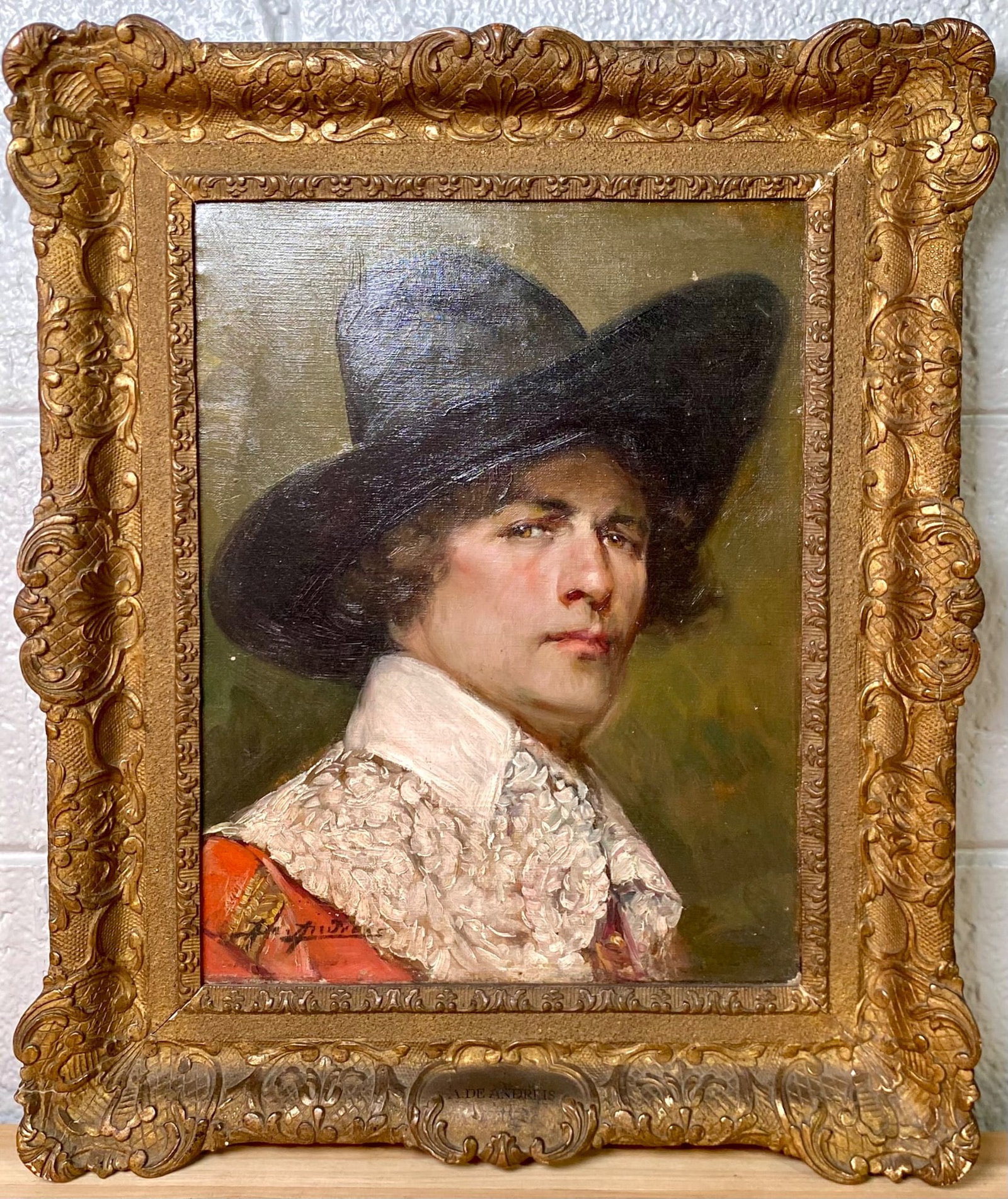 Alex De Andreis ‘Cavalier’, Oil on Canvas, Framed: Oil on canvas depicting a portrait of a cavalier, attributed to artist A. De Andreis. The piece is presented in an ornate, gilded wooden frame featuring intricate scrollwork and floral details. The si