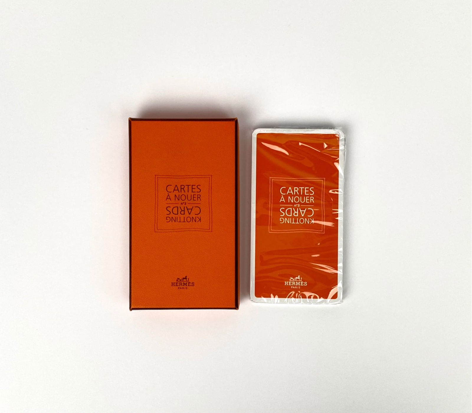 Hermes Cartes A Nouer knotting cards presented in an orange box, featuring instructions on various: Hermes Cartes A Nouer knotting cards presented in an orange box, featuring instructions on various ways to knot Hermes scarves. Cards are sealed in original plastic wrap. | Please see photos for addit