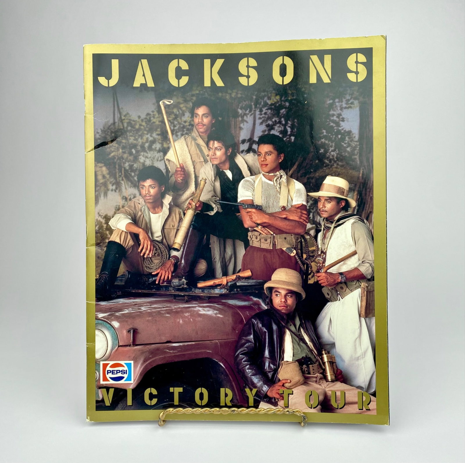 Jacksons Victory Tour Concert Program Featuring Michael Jackson, 1984: Jacksons Victory Tour program sponsored by Pepsi-Cola from 1984. Features images and promotional content related to the iconic tour, including photographs of the band, tour crew, and individual member