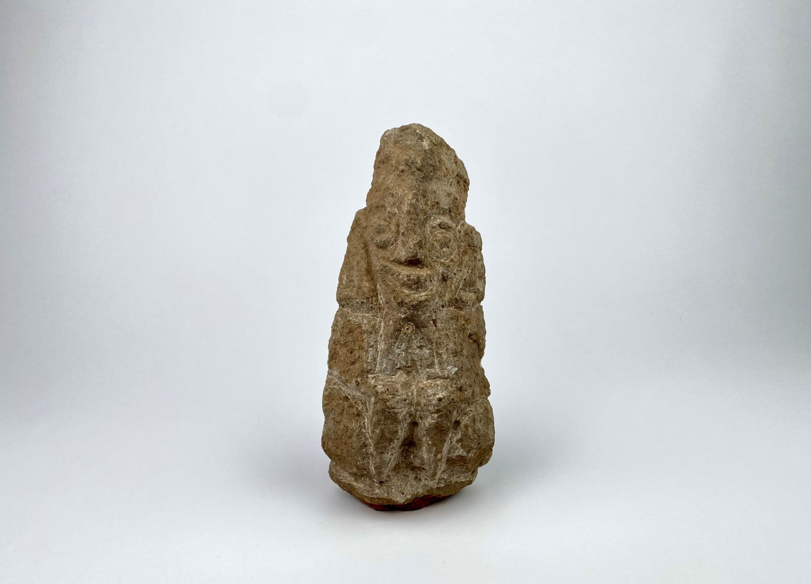 Antique carved stone sculpture featuring a stylized humanoid face motif on one side. The piece is (1 of 8)