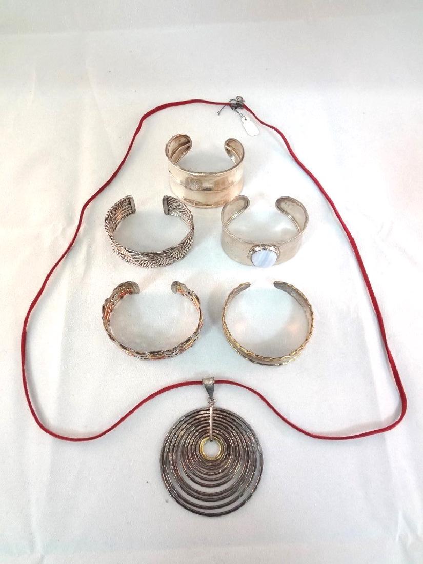 CII Mexican Sterling Silver (5) Cuff Bracelets and: CII Mexican Sterling Silver (5) Cuff Bracelets and Pendant: Great group of sterling silver from Mexico. All marked CII. Total weight of all pieces is 5.90 troy ounces.