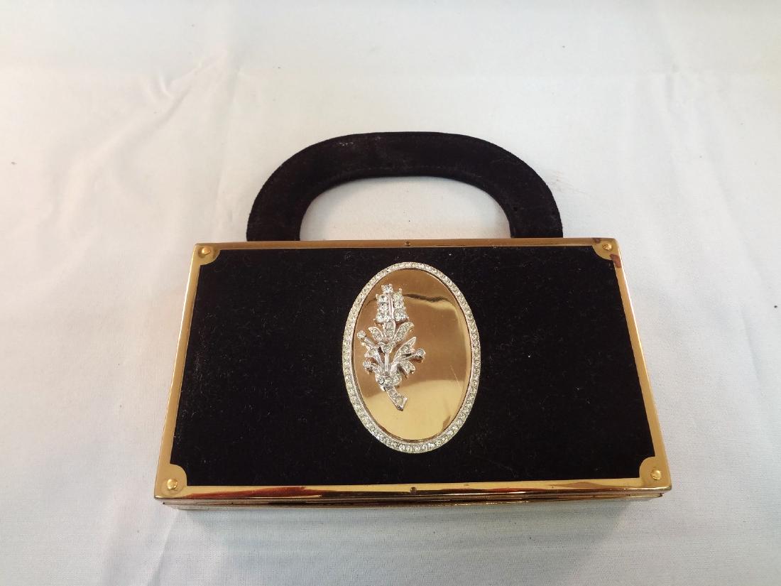 Evans All in One 1950's Cigarette/Makeup Purse: Evans All in One 1950's Cigarette/Makeup Purse: Black suede gold tone, carry all. Measures 5.5 x 3". Opens up both sides. One side is for makeup and the other is a cigarette and lighter holder.