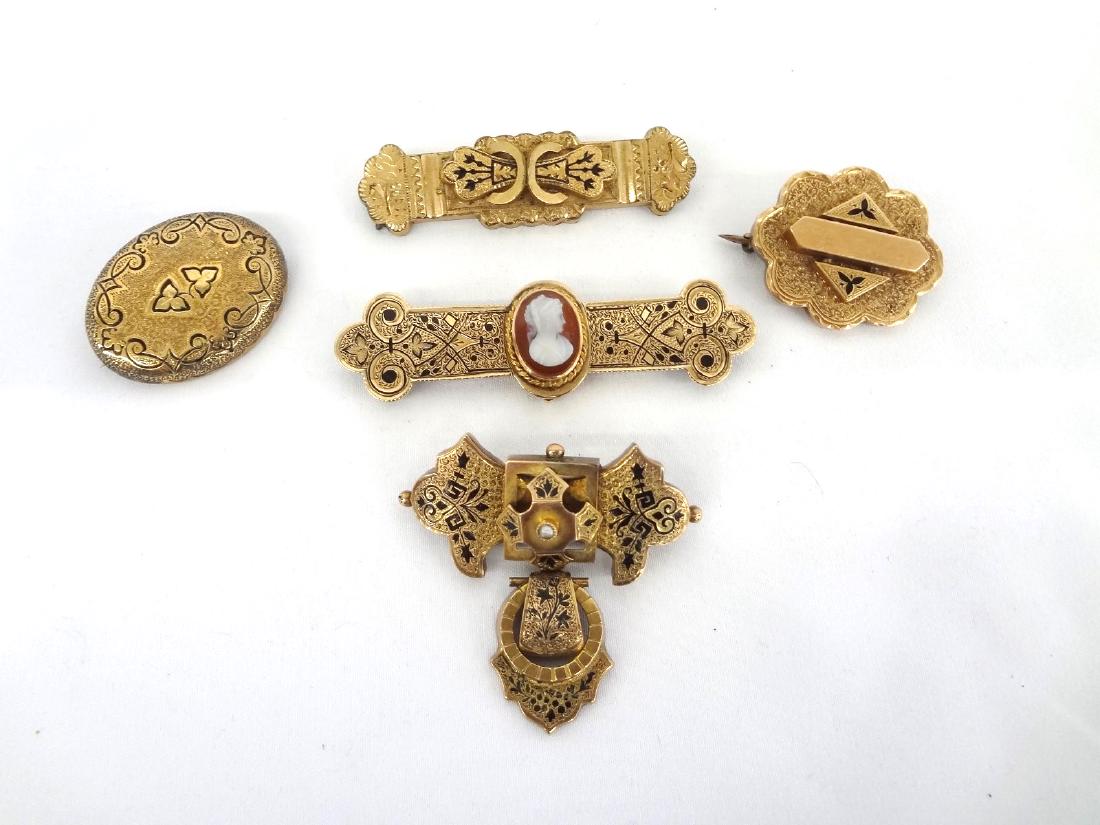 (5) Victorian Gold Filled Mourning Brooches: (5) Victorian Gold Filled Mourning Brooches: Included are 2 bar brooches with one having cameo longest 2.5", 2 oval brooches, and 1 pendant drop dangle.