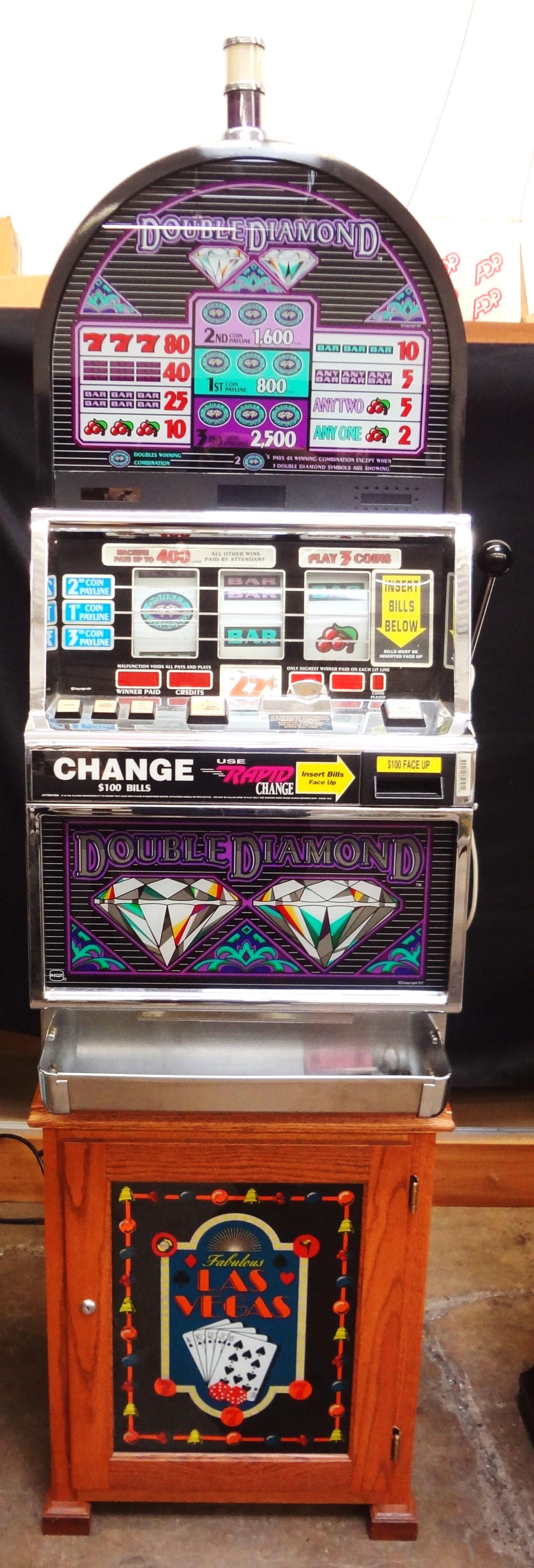 IGT Double Diamond Electric 25 Cent Slot Machine with: IGT Double Diamond Electric 25 Cent Slot Machine with Stand: Powers on and works, needs to be re-tooled for jackpot to function. Lights up and has keys. Comes on stand. Serial number 766560.