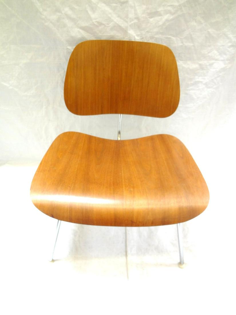 Charles Eames For Herman Miller DCM Plywood Side Chair: Charles Eames For Herman Miller DCM Plywood Side Chair: Plywood back and seat, chrome frame, white feet caps. Black rubber stoppers have been repaired. Small veneer repair. Label on bottom
