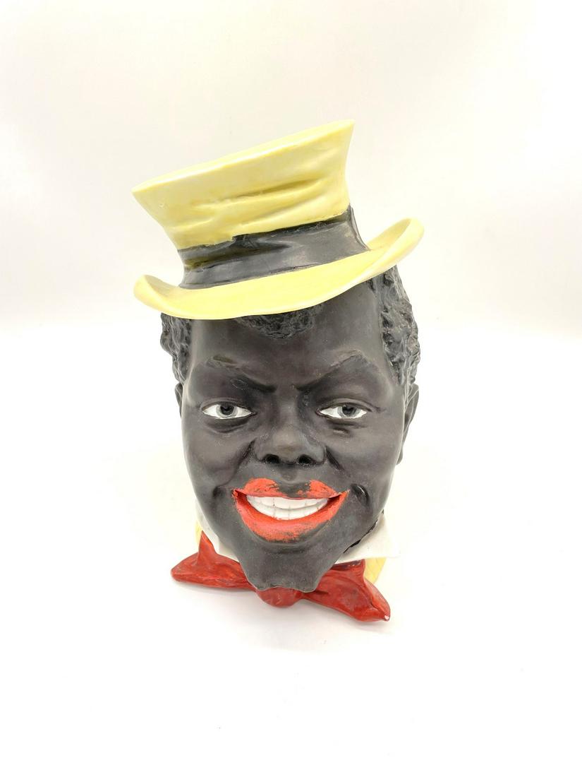 Black Americana Lidded Tobacco Jar: Black Americana Lidded Tobacco Jar: Porcelain lidded tobacco jar. One collar chip off. Paint wear throughout. Measures 7" tall, Lid and base marked "3".