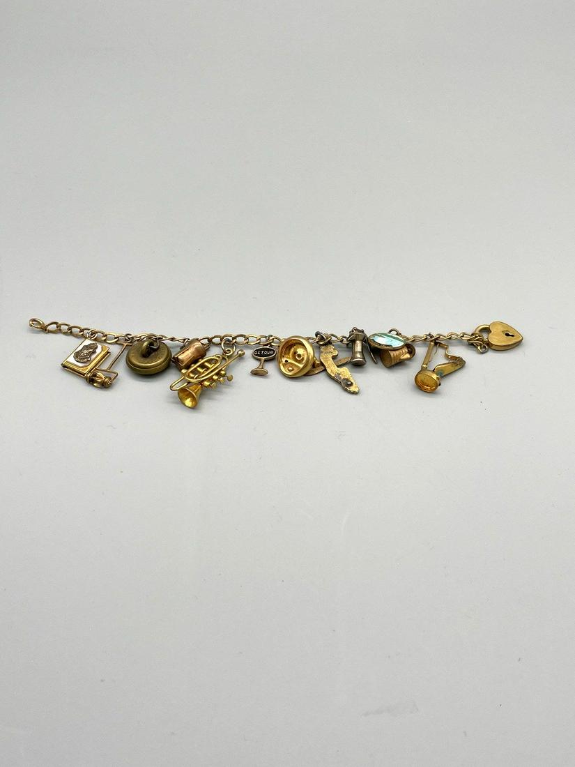 Gold Filled Charm Bracelet With 13 Charms: Gold Filled Charm Bracelet With 13 Charms: Unusual gold filled charm bracelet. Total weight is 24 grams.