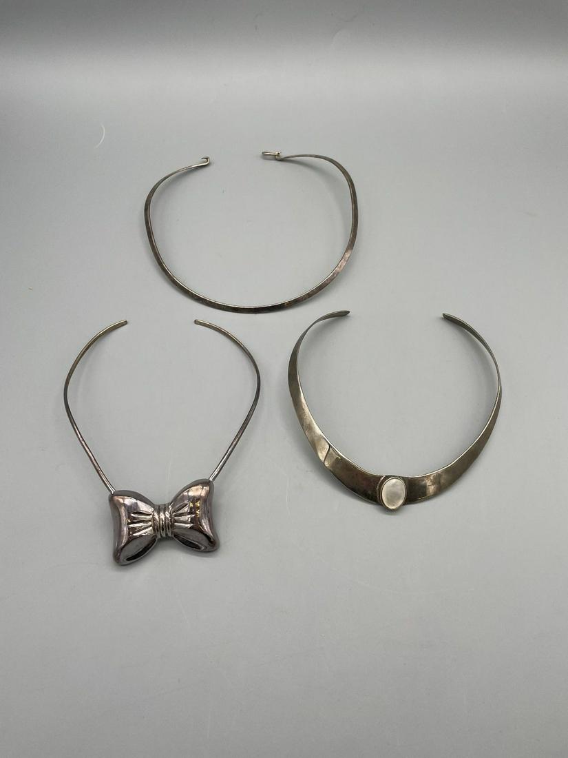 (3) Sterling Silver Chokers/Necklaces: (3) Sterling Silver Chokers/Necklaces: One with a white stone cabochon. Total weight is 89 grams.