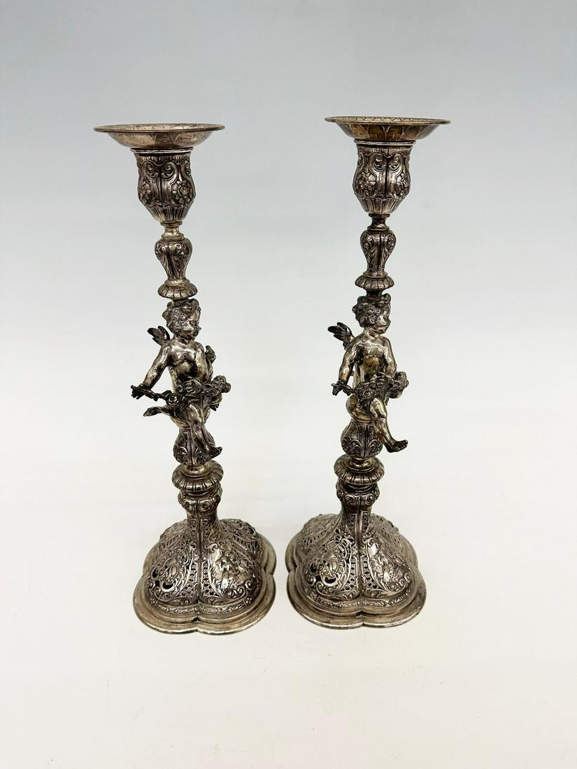 Pair Baroque Silver High Repousse Putti Candle Sticks: Pair Baroque Silver High Repousse Putti Candle Sticks: Pierced apron, putti center column, with removable candle cups. Measure 14.25". Unsigned or worn away. Excellent condition