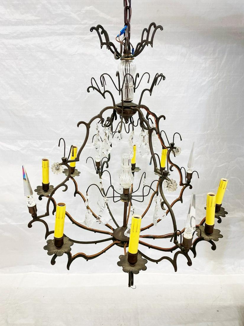 Cast Iron Eight Bulb Chandelier: Cast Iron Eight Bulb Chandelier: With hanging prisms, some top row are missing. Measures 31" tall to the top. No breaks or repairs in metal.