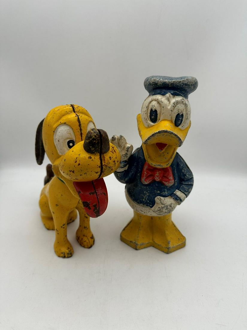 (2) Walt Disney Cast Iron Good Early Modern Still Banks: (2) Walt Disney Cast Iron Good Early Modern Still Banks: Donald Duck measuring 9.25", and Pluto measuring 8".