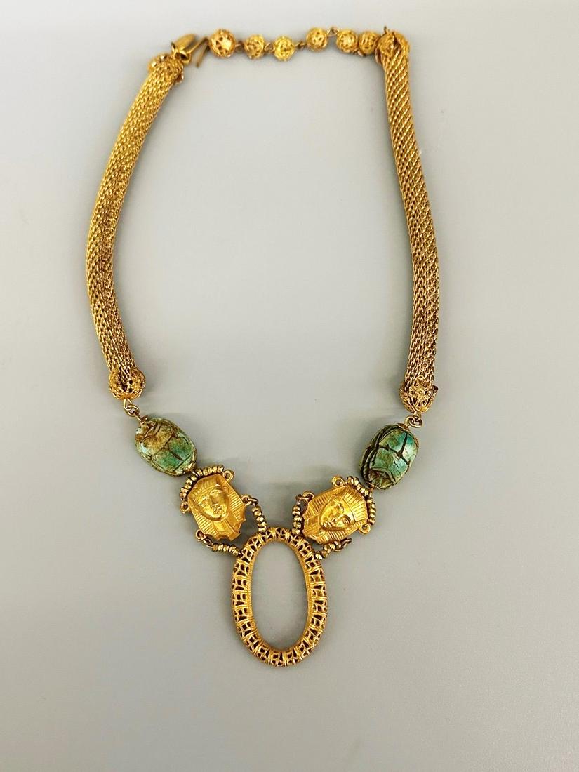 Miriam Haskell Egyptian Revival Necklace: Miriam Haskell Egyptian Revival Necklace: Egyptian revival necklace with King Tut masks and scarabs. Missing black flat stone center bottom.