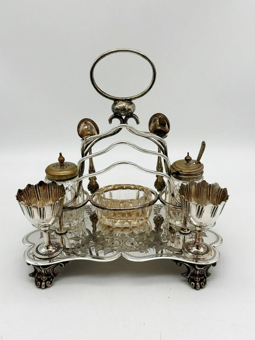 Quadruple Silver Plate Breakfast Caddy Figural Venture Slater Bros.: Quadruple Silver Plate Breakfast Caddy Figural Venture Slater Bros.: With egg cups, toast slots, 2 spoons (married to piece), condiment with lid, salt, small glass dish. Signed on bottom Vanture Slate