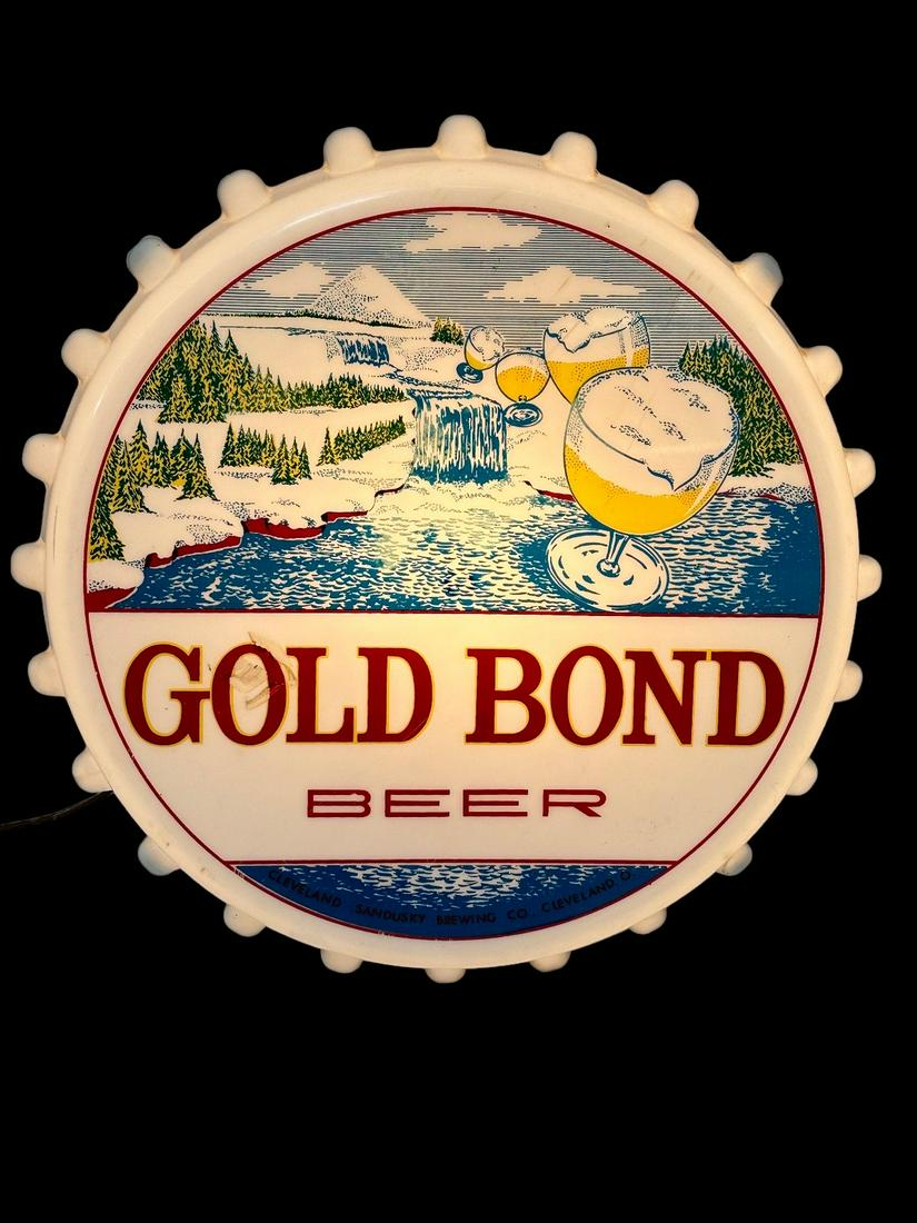 Gold Bond Beer Light Up Bottle Cap Advertising Sign: Gold Bond Beer Light Up Bottle Cap Advertising Sign: Sandusky Brewing Co. Plastic front, metal housing. Measures 16" in diameter, 4.25" deep. Three cracks present on edges on plastic. In working condi