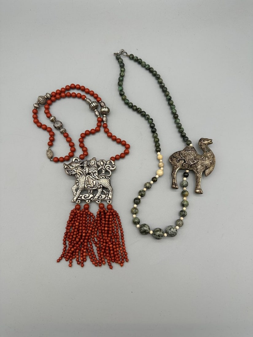 (2) Silver Alloy Amulet Necklaces Camel and Chinese Deity: (2) Silver Alloy Amulet Necklaces Camel and Chinese Deity: Silver alloy and Carnelian stone with matching earrings. Camel with green and white stones.