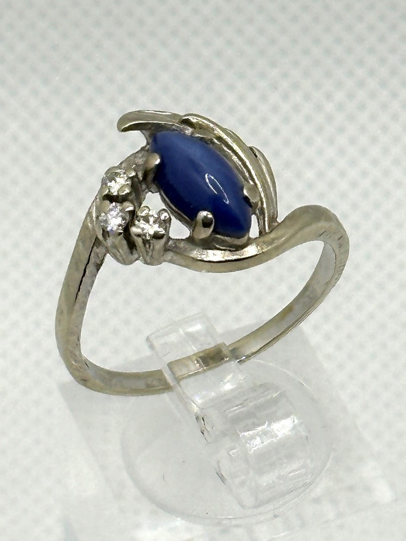 14k White Gold Star Sapphire and Diamond Ring: 14k White Gold Star Sapphire and Diamond Ring: Center oval star sapphire, and 3 diamonds. Size 9, weight is 4.3 grams.