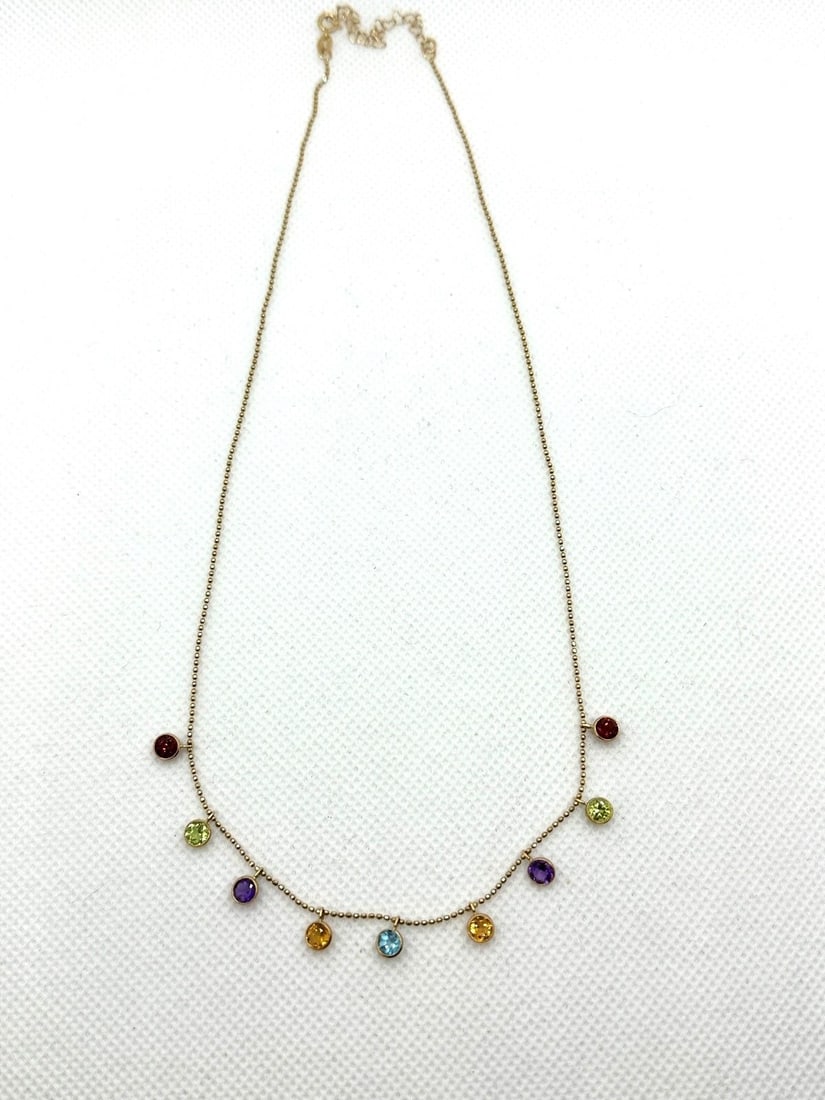 14k Yellow Gold With (9) Drop Set Gemstones: 14k Yellow Gold With (9) Drop Set Gemstones: Necklace has (2) of each of the following; garnet, peridot, amethyst, citrine, and (1) topaz. Measures 18" long. Weight is 2.8 grams.