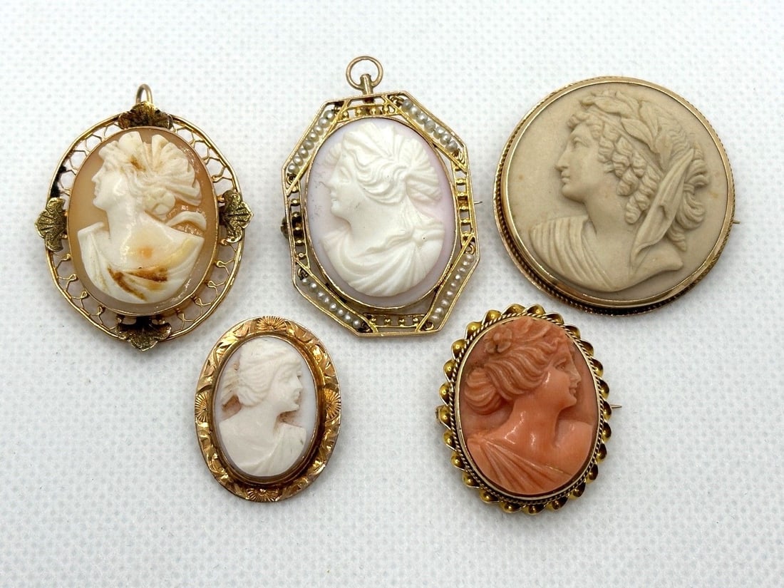(5) 10k Gold Cameos Pendant and Brooches: (5) 10k Gold Cameos Pendant and Brooches: 1 is a lava carved cameo. Largest 1.5" long. Weight is 32.2 grams.
