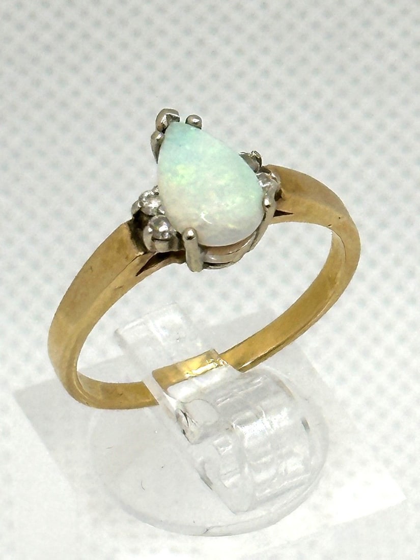14k Yellow Gold Opal and Diamond Ring: 14k Yellow Gold Opal and Diamond Ring: Opal in tear drop shape. 4 small diamond accents. Size 7.75 and weight is 2.9 grams.