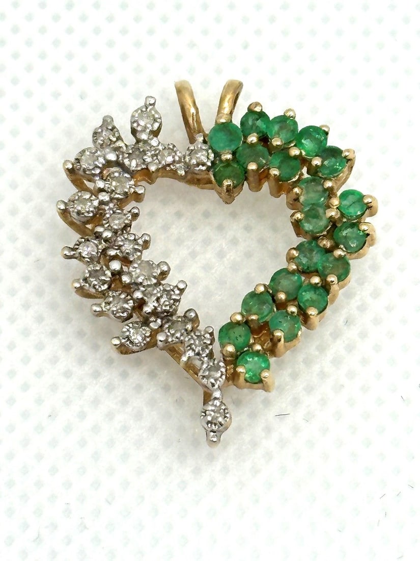 14k Yellow Gold Emerald and Diamond Heart Pendant: 14k Yellow Gold Emerald and Diamond Heart Pendant: With 20 round emeralds and diamonds. Measures 1" long. Weight is 3.8 grams.