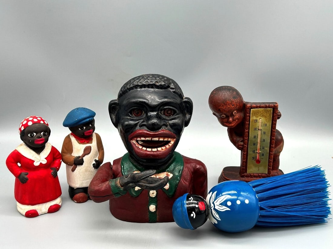 Black Americana Cast Iron Bank and Collectibles: Black Americana Cast Iron Bank and Collectibles includes a mechanical bank, salt and pepper shakers, a brush and a thermometer.