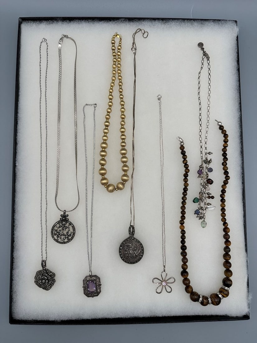 (8) Sterling Silver Necklaces: (8) Sterling Silver Necklaces : Includes marcasite, tiger eye and other stones. Total weight is 121.8 grams without the tiger eye necklace.