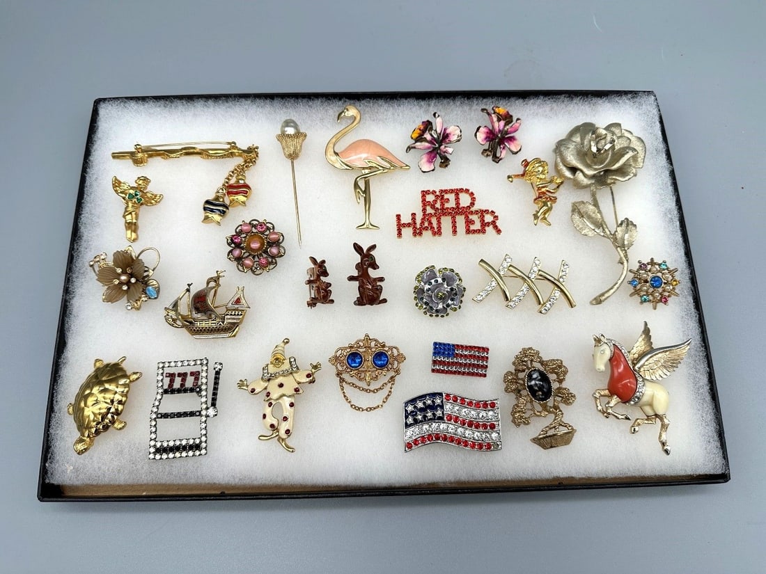 Group of Costume Jewelry: Group of Costume Jewelry: Includes Trifari, stick pin, Monet, enamel Pegasus, Flamingos, Orchids, clown and Kangaroo. Damascene ship, 24 brooches.
