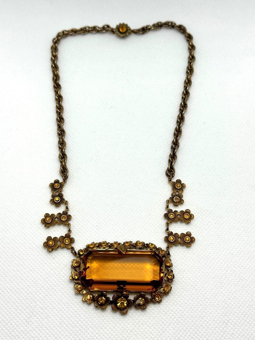 Victorian Mourning Statement Necklace: Victorian Mourning Statement Necklace: Has large amber colored stone center, with matching stones on clasp with surrounding daisy accents with stones.