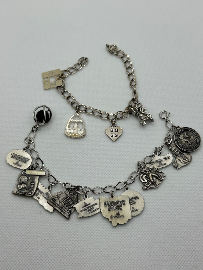 (2) Sterling Silver Charm Bracelets: (2) Sterling Silver Charm Bracelets: Includes train, Wash. D.C., Big Sis 4 in all 7". 12 Ohio charms 7". Total weight is 57.9 grams.