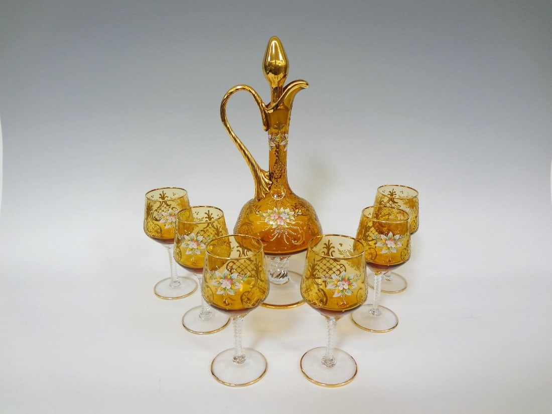 Lavorazione a Mano Italian Decanter and Amber Glass Set: Lavorazione a Mano Italian Decanter and Glass Set: Accented in gold and enameled flowers, decanter measures 15" tall, with 6 stemmed glassed. Columns swirled with matching floral motif measuring 6.5".