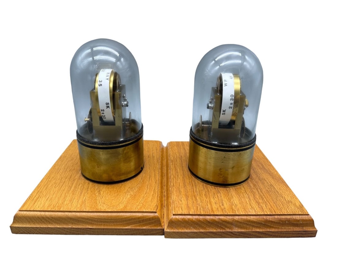 (2) Edison Stock Ticker Tape Machines Under Domes: (2) Edison Stock Ticker Tape Machines Under Domes: By Solar Art measuring 7" tall.