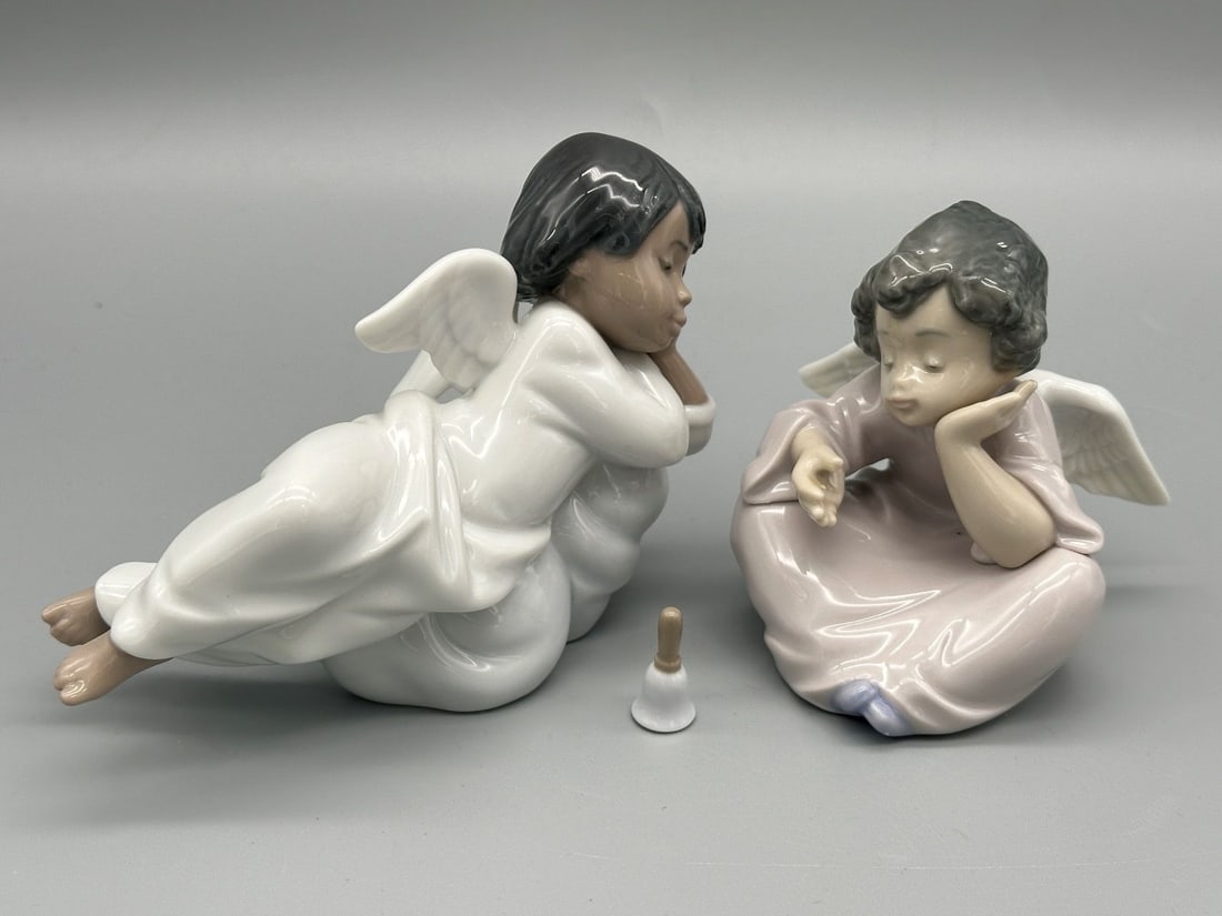 (2) Lladro Porcelain Figurines Black Legacy "Heavenly Dreamer and Chimes": (2) Lladro Porcelain Figurines Black Legacy “Heavenly Dreamer and Chimes": On Heavenly Chimes, bell has been re-glued. Measure 3" and 3.75".