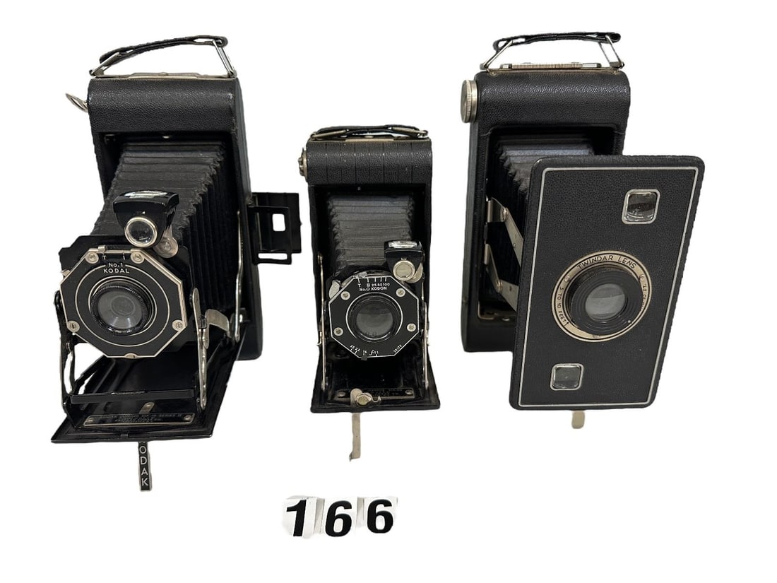 (3) 1930's Folding Kodak Cameras: (3) 1930's Folding Kodak Cameras: I. The first camera in this lot is the Jiffy Kodak Six-16 Series II 1937-1942. The bellows of this rollfilm camera pop out with the help of the twin spring struts. Th