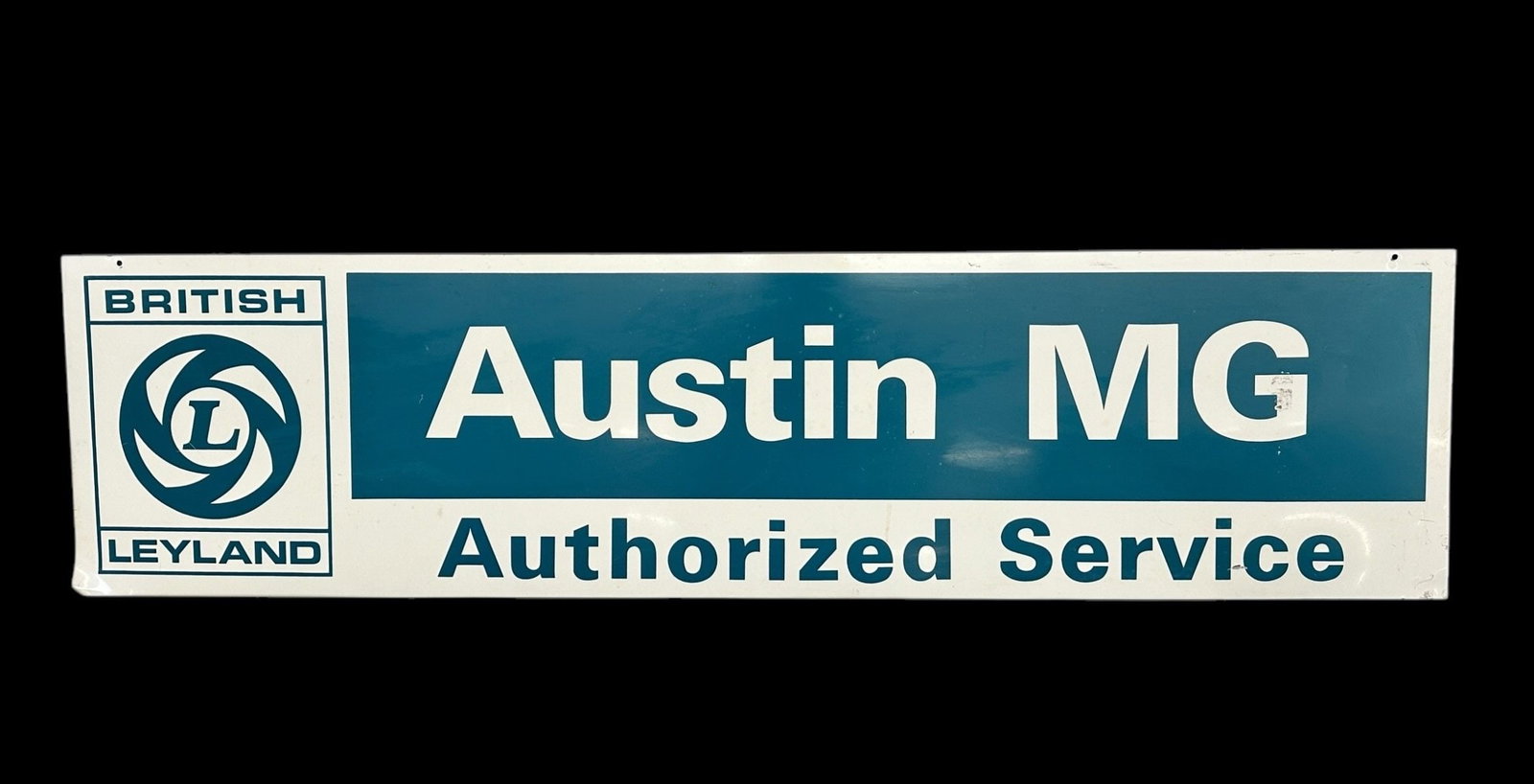 British Leyland Austin MG Authorized Service Metal Advertising Sign: British Leyland Austin MG Authorized Service Metal Advertising Sign. This one sided sign measures 48 x 12".