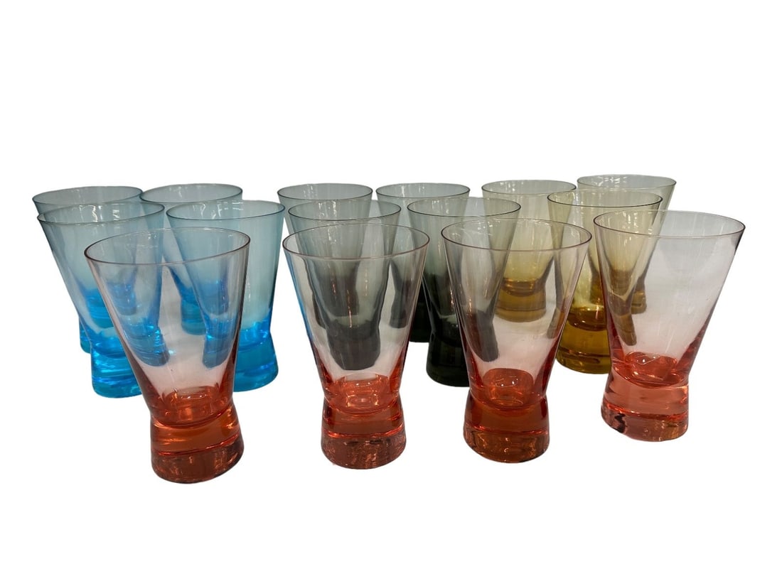 (15) Mid Century Colored High Ball Glasses: (15) Mid Century Colored High Ball Glasses: (4) in each of the following colors; blue, smoke (2) have tiny chips, pink and (3) yellow. All 6" tall.