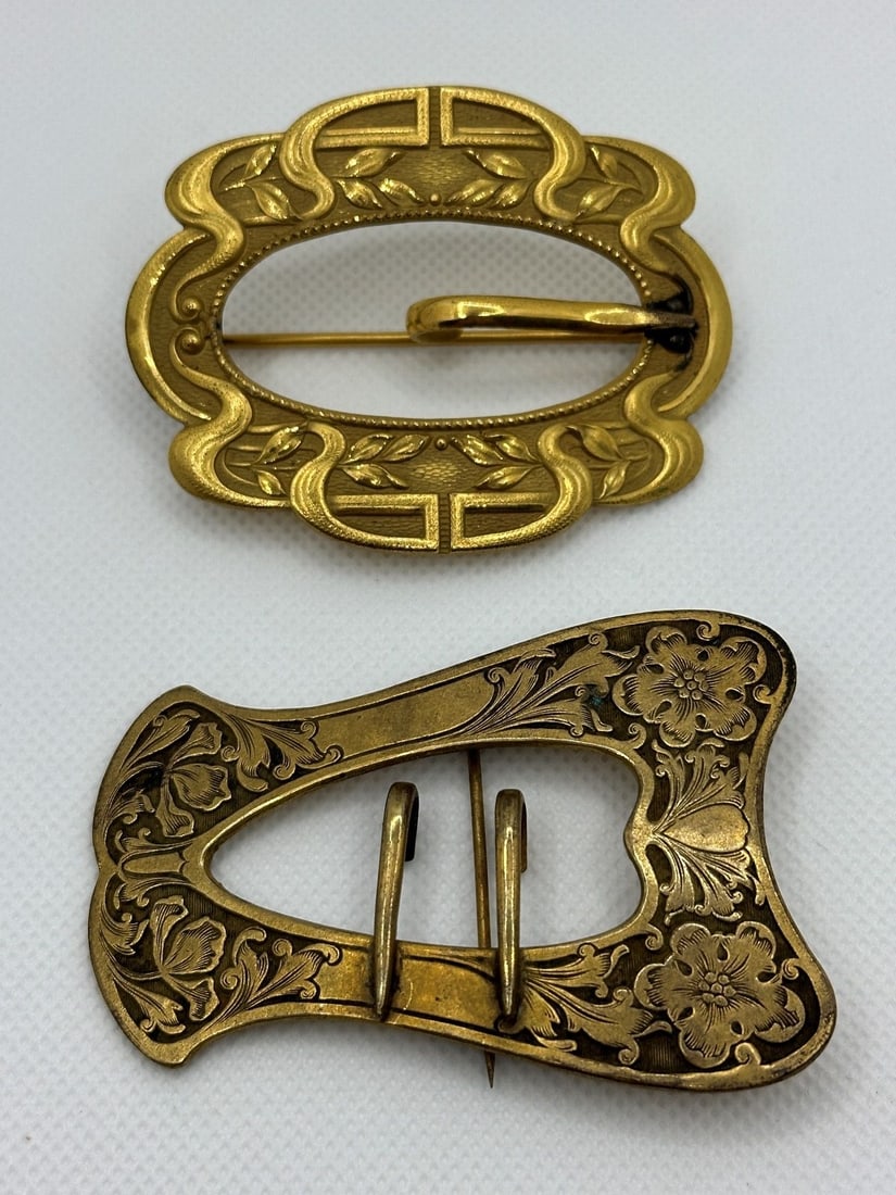 (2) Brass Art Nouveau Sash Brooches: (2) Brass Art Nouveau Sash Brooches: Art Nouveau designs in gold wash. Marked JJS for J.J. Sommer Co. Measure 2.75 and 3".